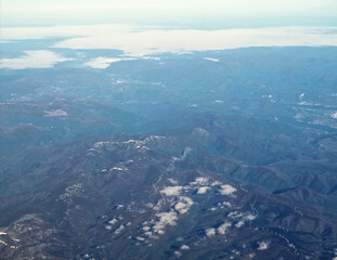 Fototapeta premium aerial view of spanish mountains with snow and clouds