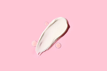 Samples of cosmetic cream and gel on pink background
