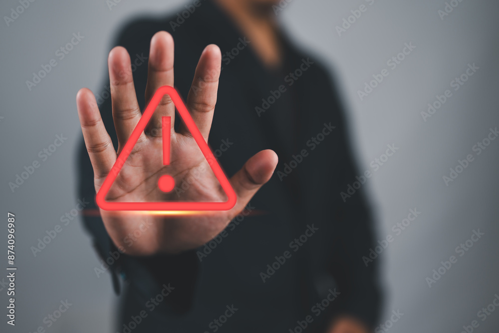 Poster Human hand showing red triangle caution warning sign for maintenance notification error and risk concept.
