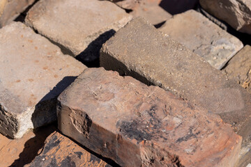 old used bricks made of red clay and other materials