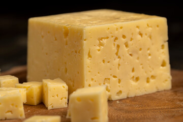 a piece of cheese with holes on the table
