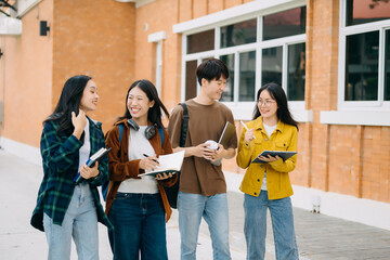 Young Asian People college students and a female student group work at the campus park