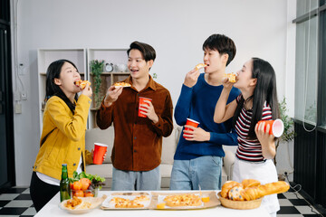 Group of Young Asian friend having, enjoy evening party together at home. Attractive young man and woman having fun, eating food, celebrate at home