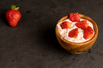 yogurt made from milk with added flavor and pieces of ripe strawberries