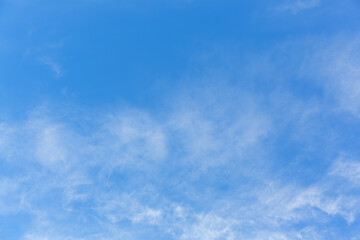 Image of a layer of thin white clouds against a blue sky.