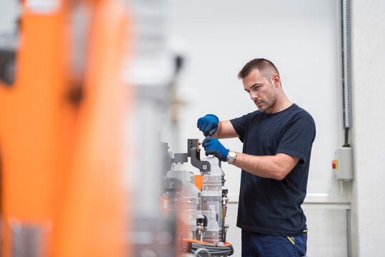 Engineer repairing machinery in factory