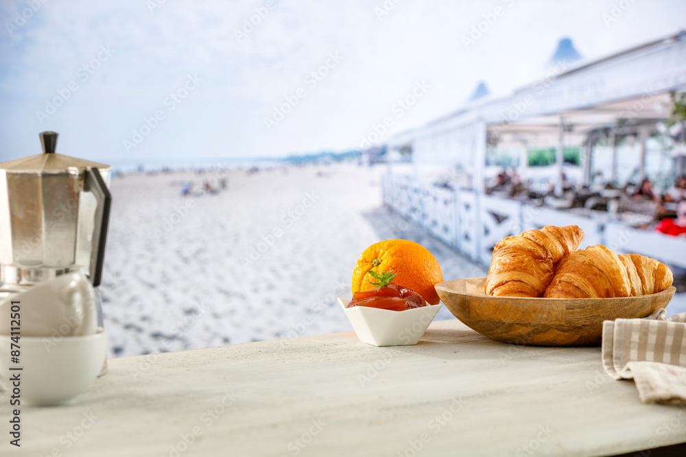 Wall mural summer continental breakfast on a beach. croissants, jam and fruit on a wooden table. summer table b