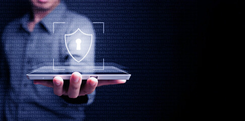 Cyber security data protection. The man uses a virtual digital shield on his tablet computer to...