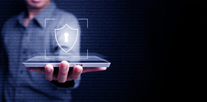 Cyber security data protection. The man uses a virtual digital shield on his tablet computer to protect his personal data and cybersecurity. Safe and secure internet network connection.
