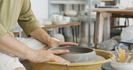 Potter Crafting Large Bowl in Clay Workshop