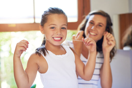 Girl, cleaning teeth and portrait with dental floss in home for oral care, hygiene and wellness. Female person, woman and morning routine for gum health, growth and development in bonding with parent - Powered by Adobe