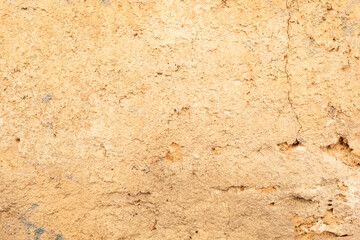 A close up of a cracked and weathered wall