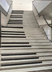 Piano Staircase. A Symbol of Life's Success, Painted Black and White with Handrails Inside a School Building.