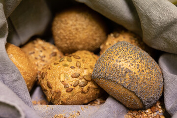 A collection of freshly baked rolls each with its own unique topping