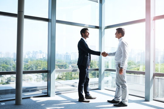 Business men, handshake and meeting with welcome for thank you, greeting or introduction in office. Partnership, commercial realtor and client shaking hands for agreement, b2b deal or acquisition