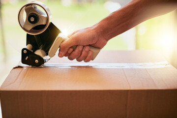 Box, hand and tape with person packing in home on moving day for courier shipping or relocation....