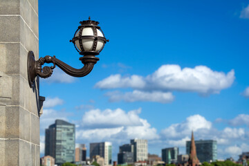 Classic lamp on the stone pillar of Longfellow Bridge with Boston’s skyline in the distance, MA, USA