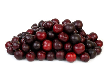 Heap of many ripe plums isolated on white background.