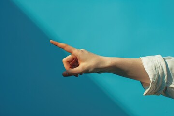 A person gestures towards something with their finger