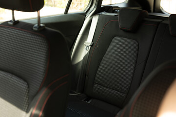 Black leather seats with red stitching in a car