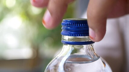 slow motion of open a cap of a water bottle - Powered by Adobe