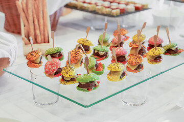 catering buffet with variety of food snacks and appetizers.
