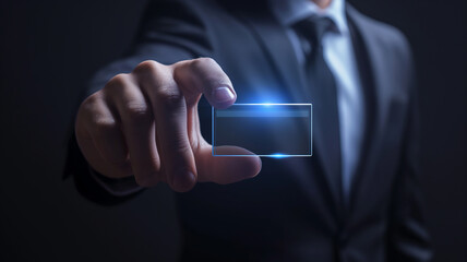 Business concept. Businessman holding holographic empty identification card. Businessman presenting his electronic business card. Empty space for text or graphics.