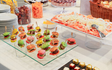catering buffet with variety of food snacks and appetizers.