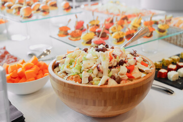 catering buffet with variety of food snacks and appetizers.