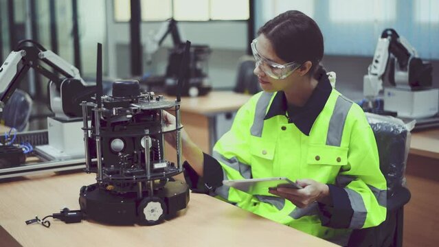 Engineer factory industry control learning and analyses welding robot arms machine is intelligent industrial system with automate technology system for factory industry manufacture concept.