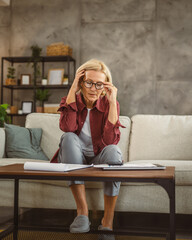 Mature senior woman work from home and have headache pain