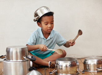 House, kid and noise of pots for drum, rhythm and coordination for motor skills with metal beat....
