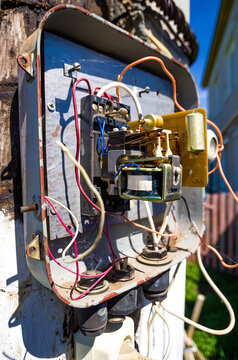 Close-up of an electrical panel and street meter on a rusted outdoor utility box