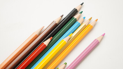A row of pencils with different colors, including red, yellow, green, and blue