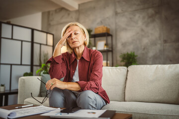Mature senior woman work from home and have headache pain