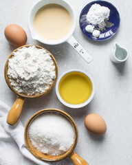 Overhead view of mise en place of ingredients for making a vanilla cake, flatlay of ingredients for making vanilla pound cake, process of making cake