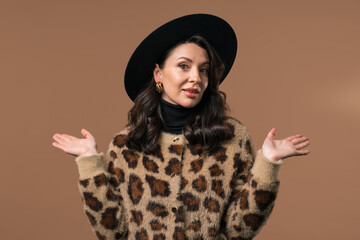 Confused mature woman, shoulders up - can't help, makes gesture of I dont know
