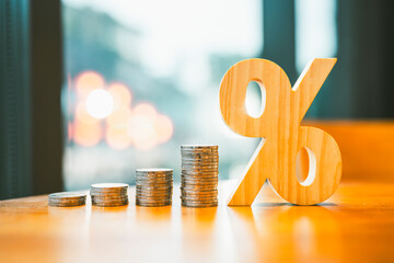 Percentage model with coins stack. Concepts of the banking system, rising interest rates, inflation, deflation, and savings.	