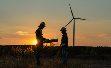 Engineer and energy farming. windmills with the silhouette of a sunset background.