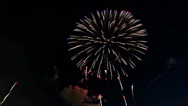 Fireworks exploding in the night sky spelling "Yay", celebration 