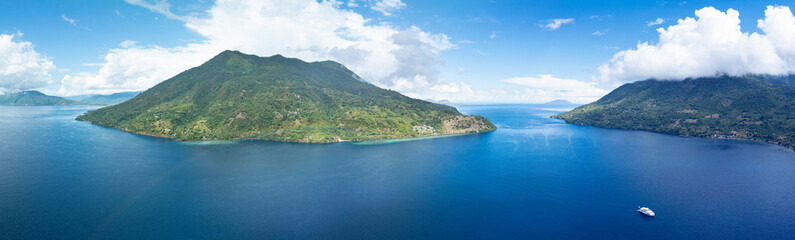 Pulau Pura, a scenic volcano, sits in the middle of the Pantar Strait between Alor and Pantar, Indonesia. The island supports beautiful coral reefs and a wide variety of colorful reef fish.