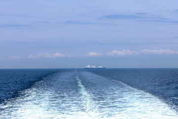 Water trail behind cruise ship. Summer travel concept. High quality photo