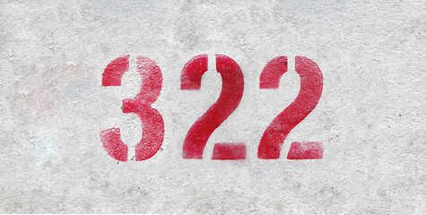 Red Number 322 on the white wall. Spray paint.