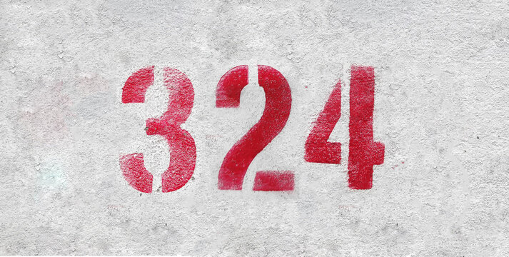 Red Number 324 on the white wall. Spray paint.