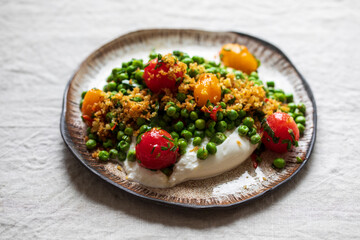 Burrata cheese with grilled green peas, pickled tomatoes and breadcrumbs