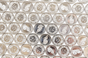coins linearly spread on white background