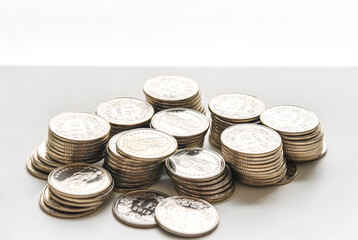 stack of coins spread on white background