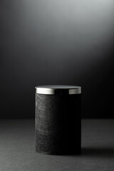 Black podium on a black background.