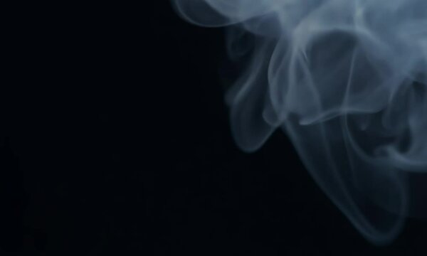 A black background withdefocused smoke. The line is thin and it is in the middle of the background