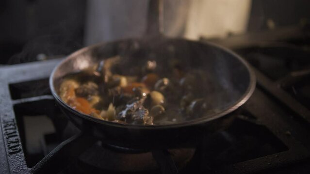 Chef preparing delicious escargot dish